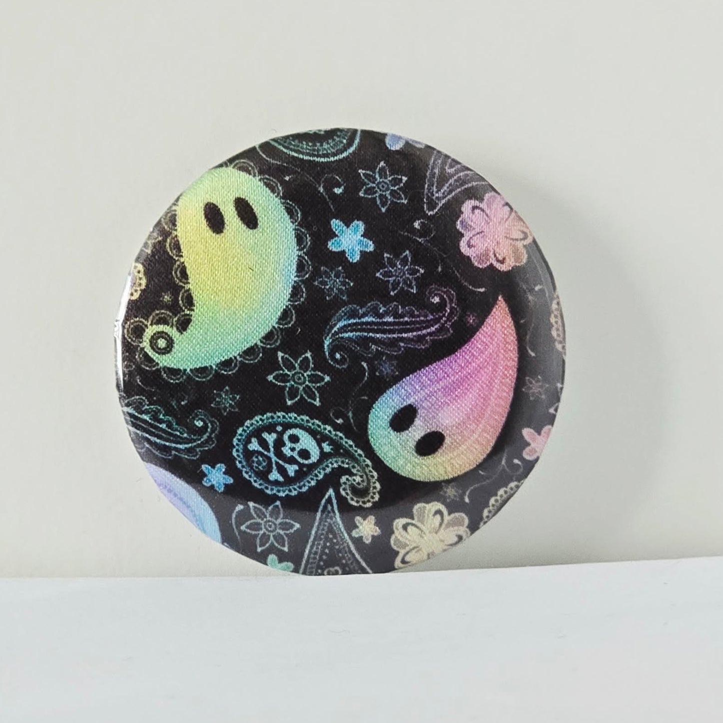 Circular product with ghost and paisley design on a white background