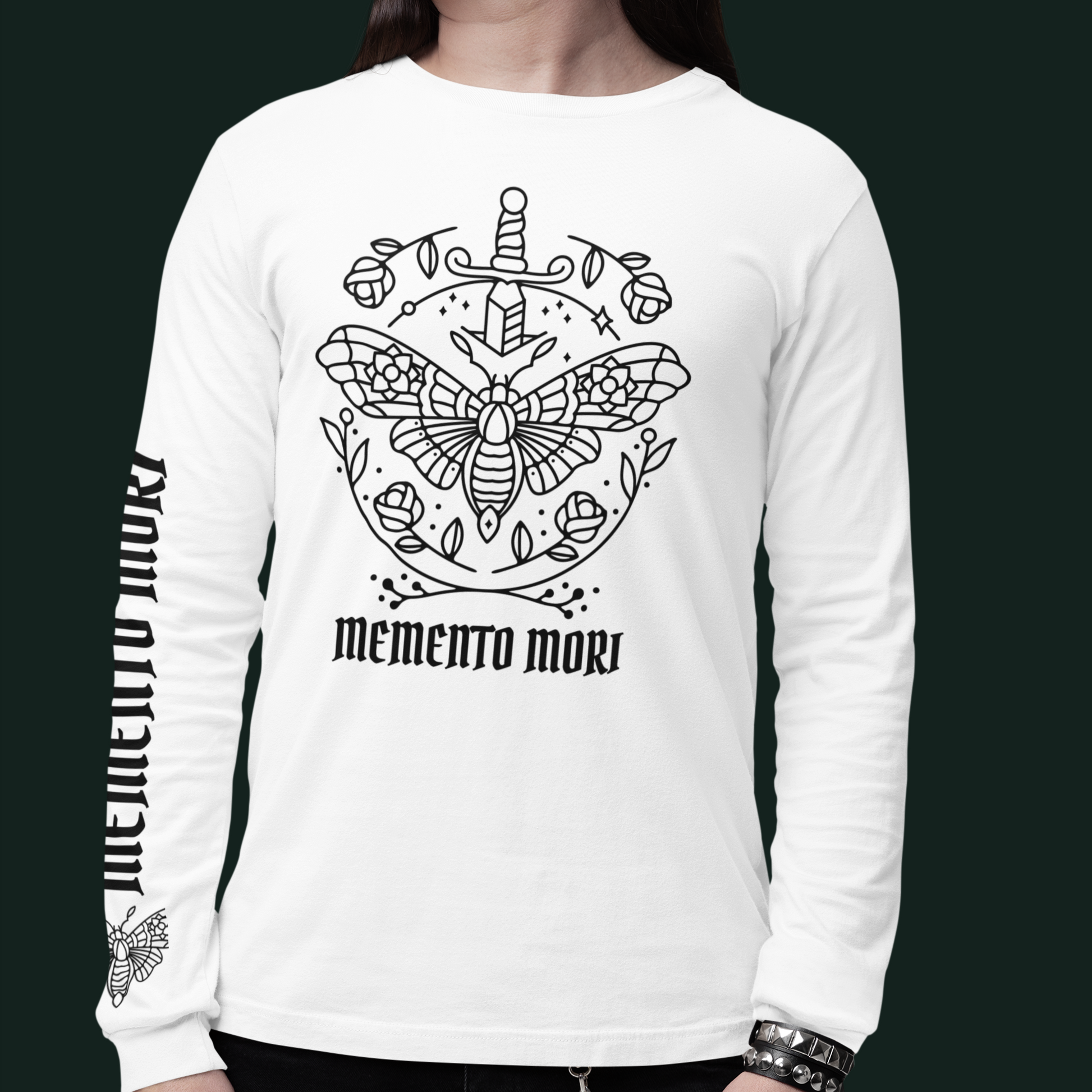 Person wearing a white long-sleeve shirt with black graphic design and 'memento mori' text.