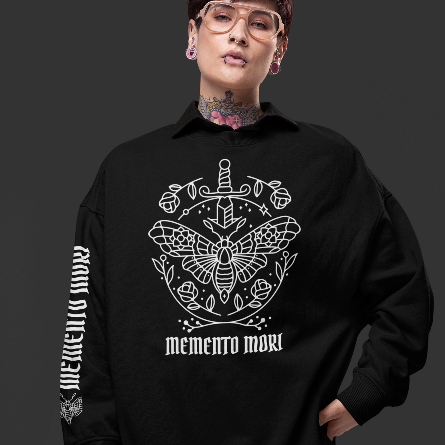 Person wearing a black sweatshirt with white graphic design and text on a dark background