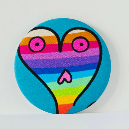 Colourful heart-shaped object with rainbow stripes on a blue background
