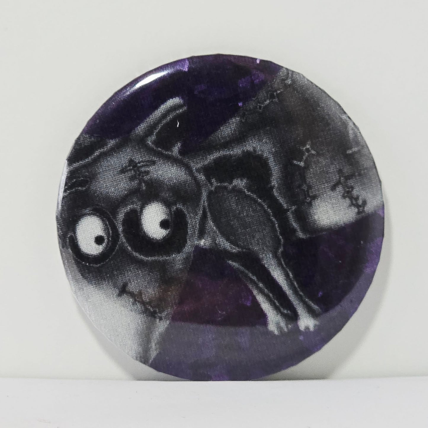 Circular badge with a black and white illustration of a dog on a purple background