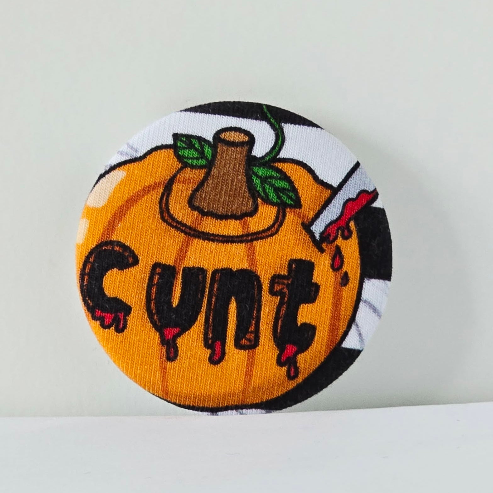 Pumpkin-shaped patch with 'Cunt' text on a white background