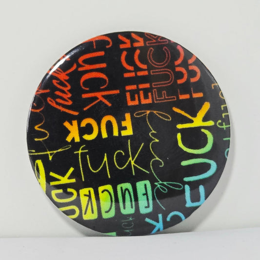 Round button badge with colorful 'FUCK' text on a black background