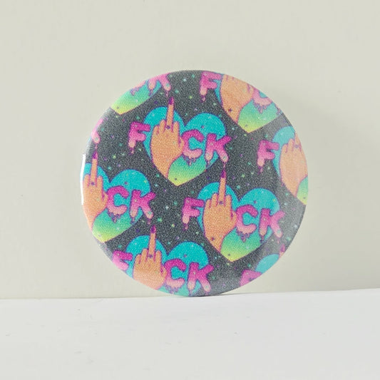 Round product with colorful 'F' and middle finger symbols on a gray background