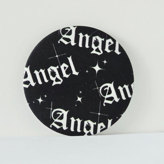 Circular black coaster with 'Angel' text and star patterns on a white background