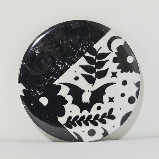 Round black and white patterned object on a light gray background
