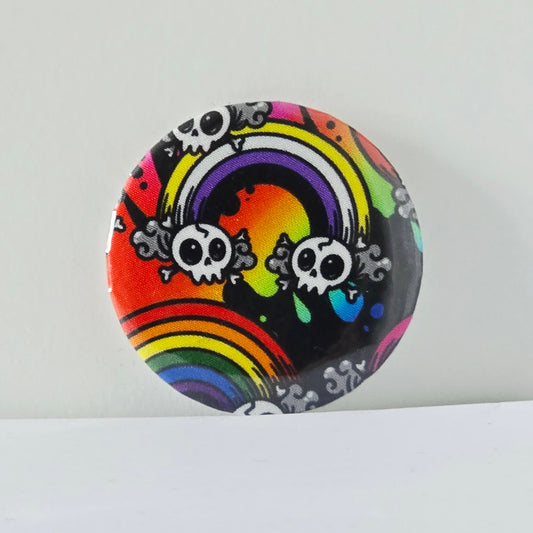 Colorful button with rainbow and skull design on a white background