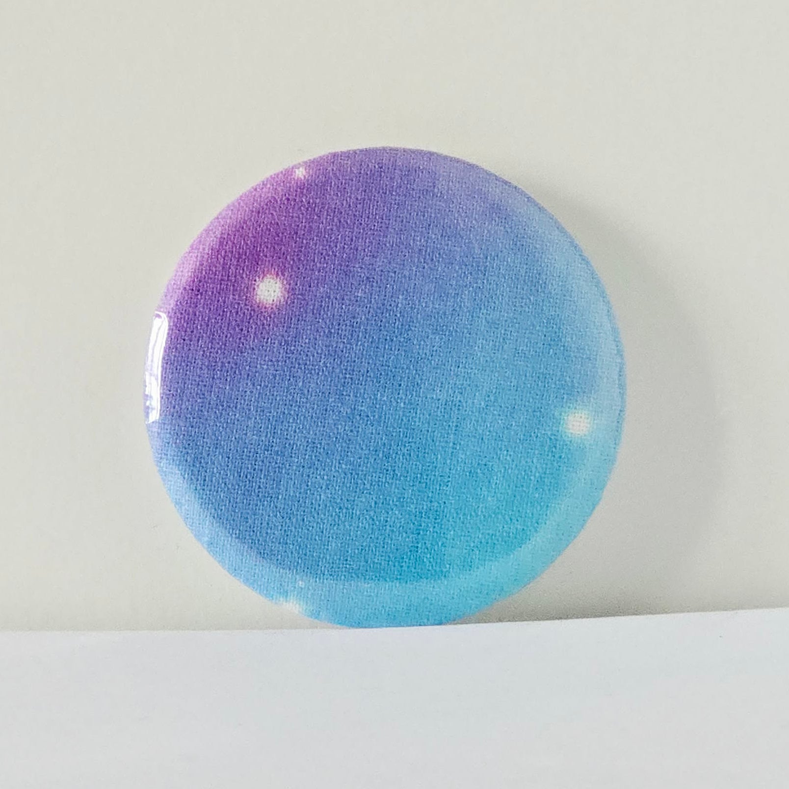 Round, gradient-colored object on a light gray background