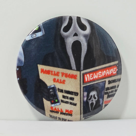 Button badge with Ghostface from 'Scream' movie design on a white background
