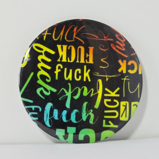 Round black coaster with colorful 'fuck' text on a white background