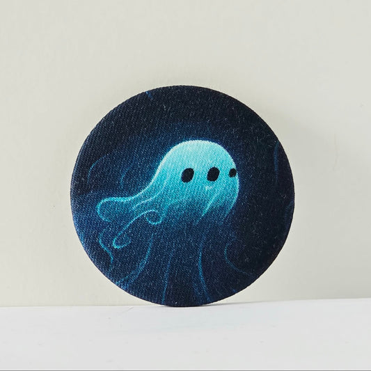 Circular dark blue fabric patch with a light blue jellyfish design on a white background